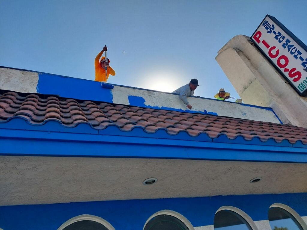 Trabajadores en la parte superior de un comercio